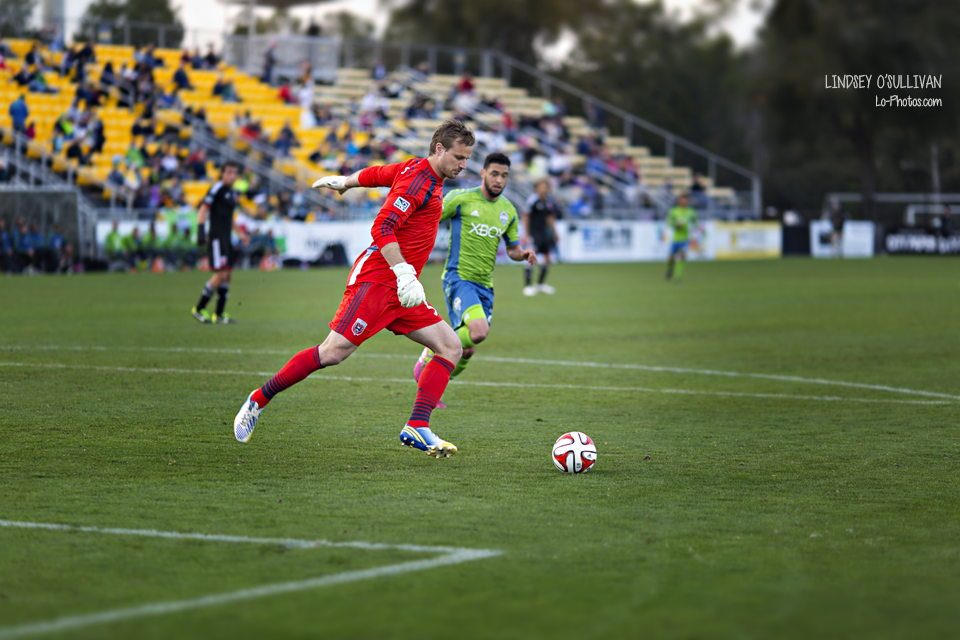 Close-up action shot from a Seattle Sounders soccer game.