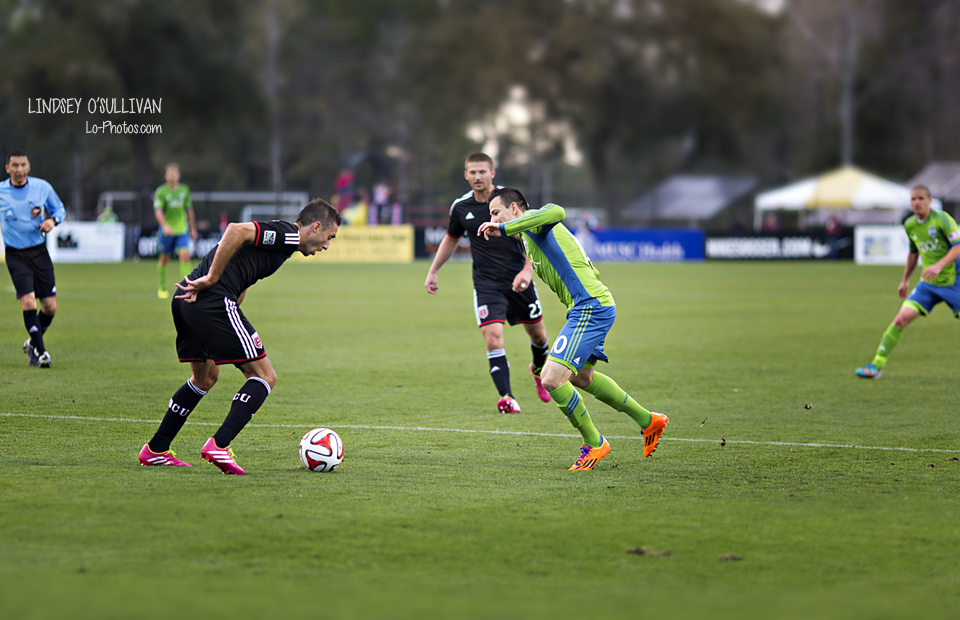 Crowd and players during a Seattle Sounders soccer match in Charleston.