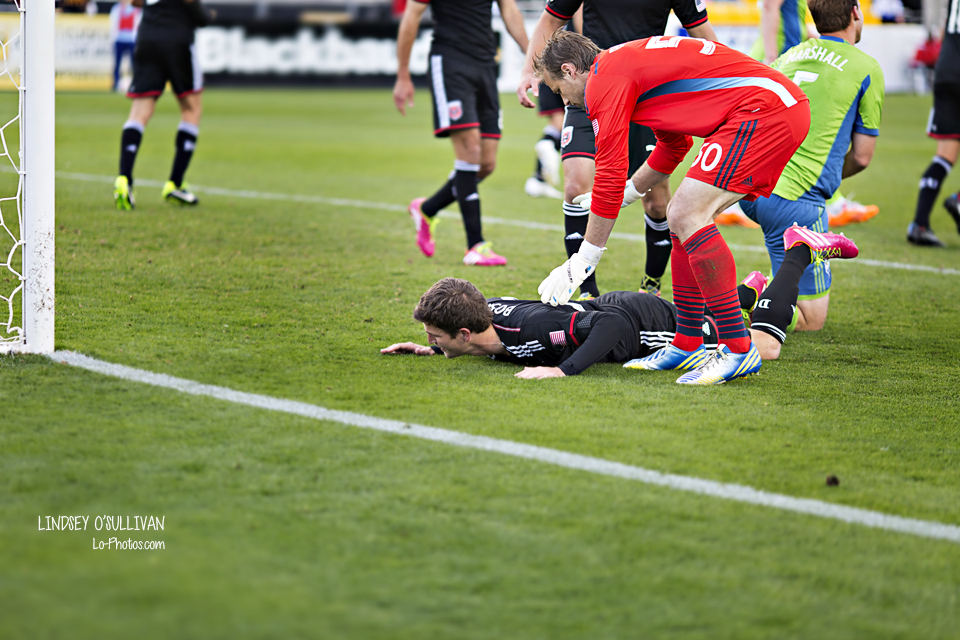 DC United and Seattle Sounders players competing on the pitch.