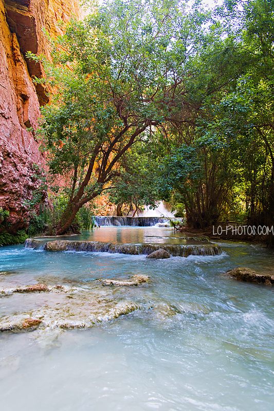 Turquoise water of Havasu Falls pouring over red rock in Arizona