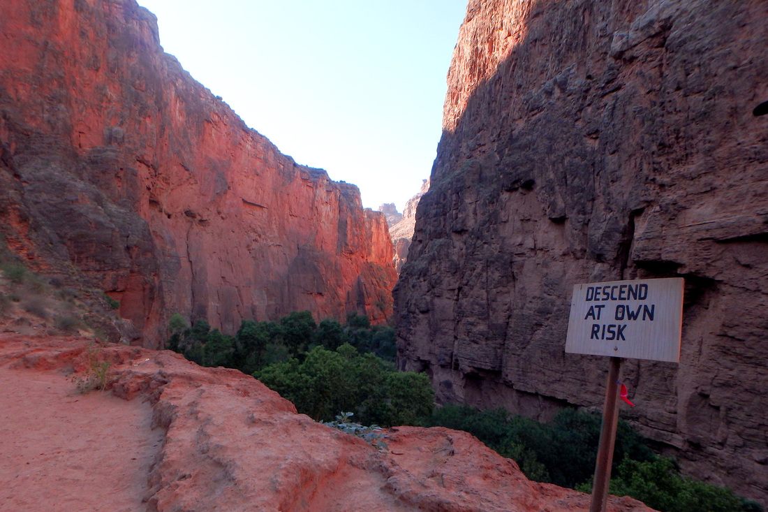 Turquoise water of Havasu Falls pouring over red rock in Arizona