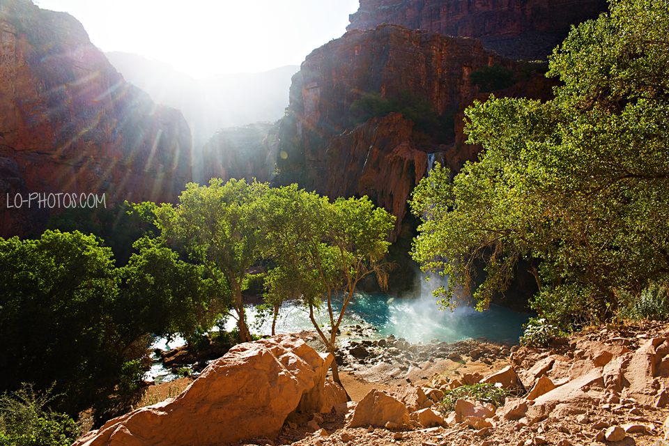 Turquoise water of Havasu Falls pouring over red rock in Arizona