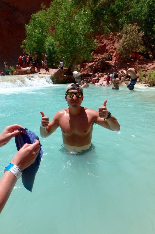Turquoise water of Havasu Falls pouring over red rock in Arizona