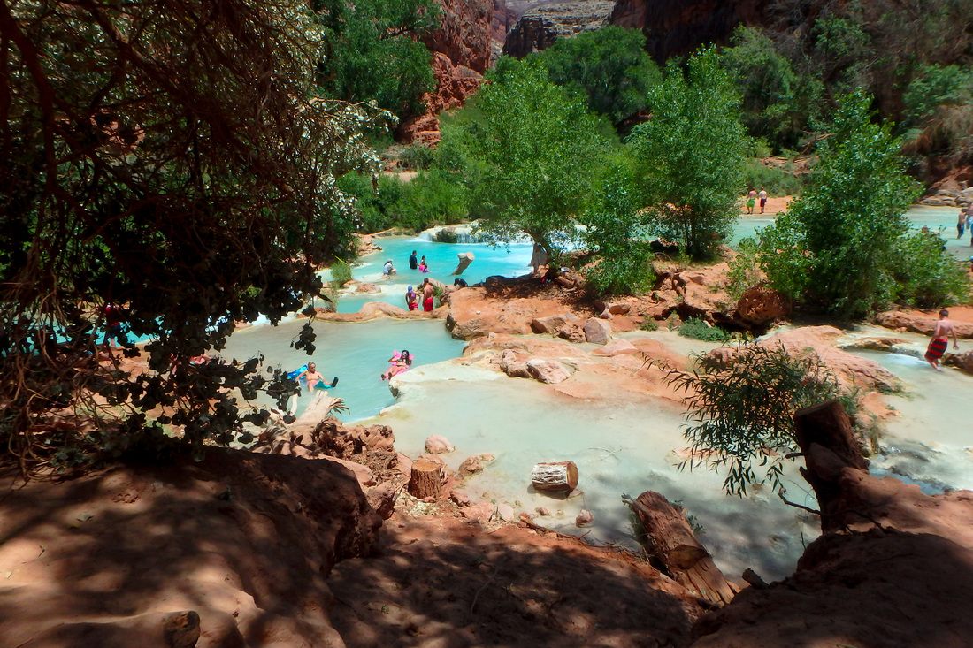 Mooney Falls dropping dramatically into a canyon pool in Havasupai