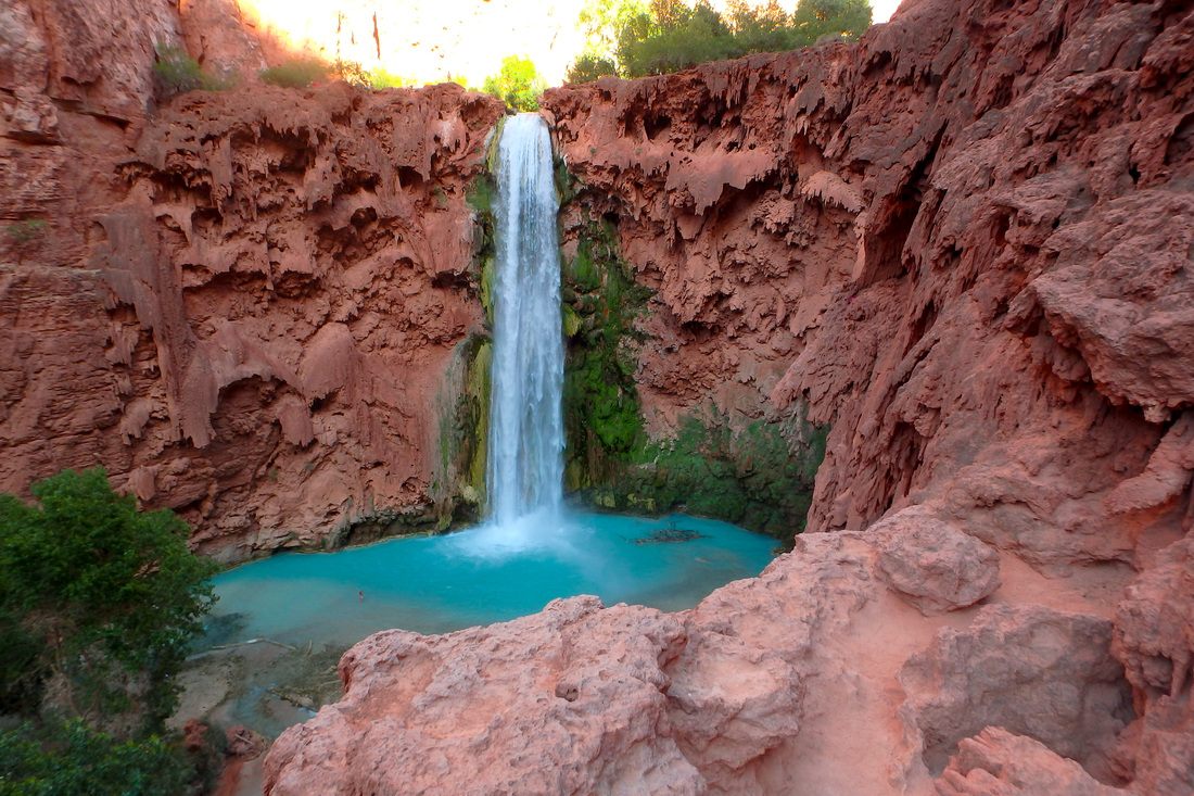 Mooney Falls dropping dramatically into a canyon pool in Havasupai