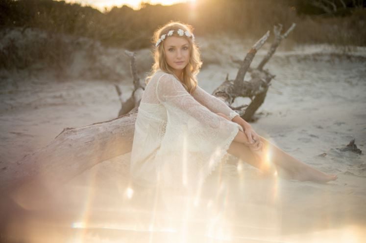 Model wearing a flowing Free People dress on the sand at Folly Beach