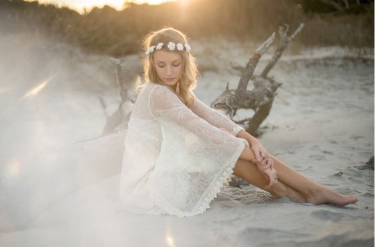 Model wearing a flowing Free People dress on the sand at Folly Beach