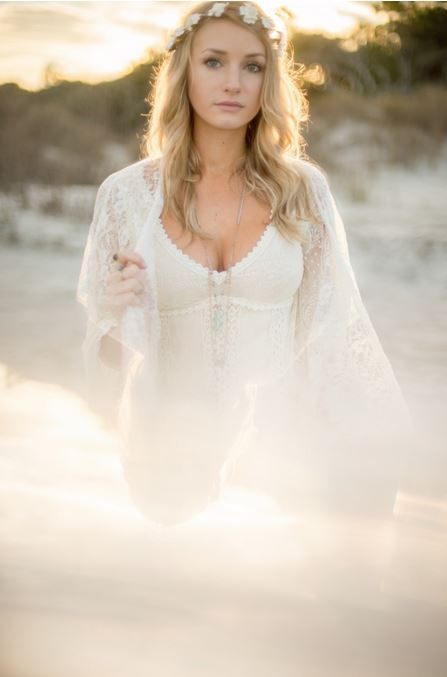 Model wearing a flowing Free People dress on the sand at Folly Beach