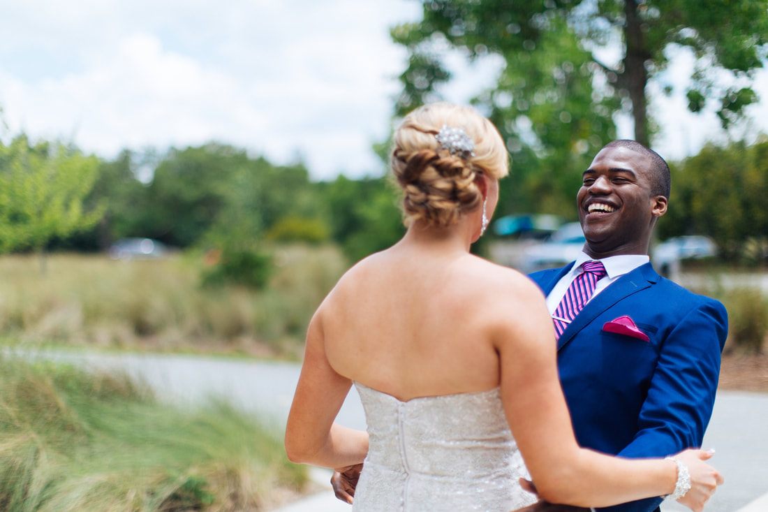 Wedding couple portrait beneath moss-draped trees in Charleston, South Carolina.