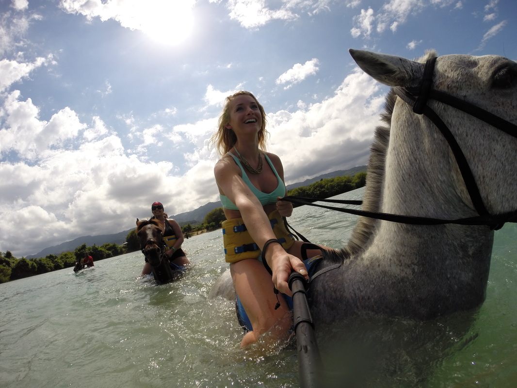 Horseback riding along the beach on the coast of Jamaica