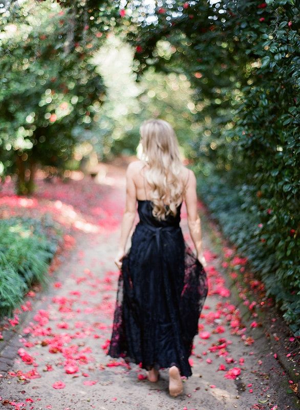 Flowing wedding gown by Shop Gossamer photographed in Charleston's gardens.