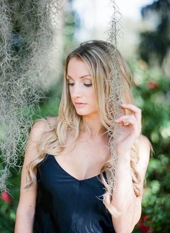 Flowing wedding gown by Shop Gossamer photographed in Charleston's gardens.