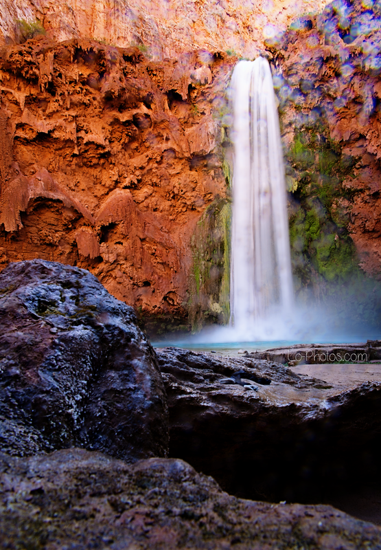 Turquoise waterfall cascading through the red rock canyon of Havasupai, Arizona