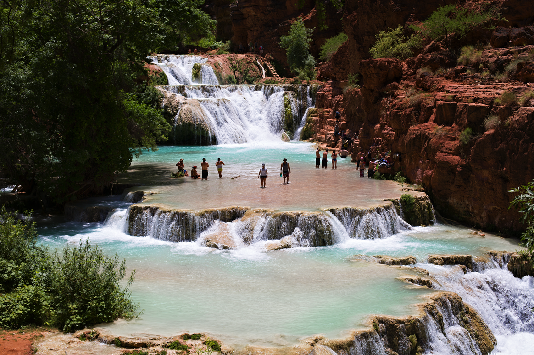 Turquoise waterfall cascading through the red rock canyon of Havasupai, Arizona