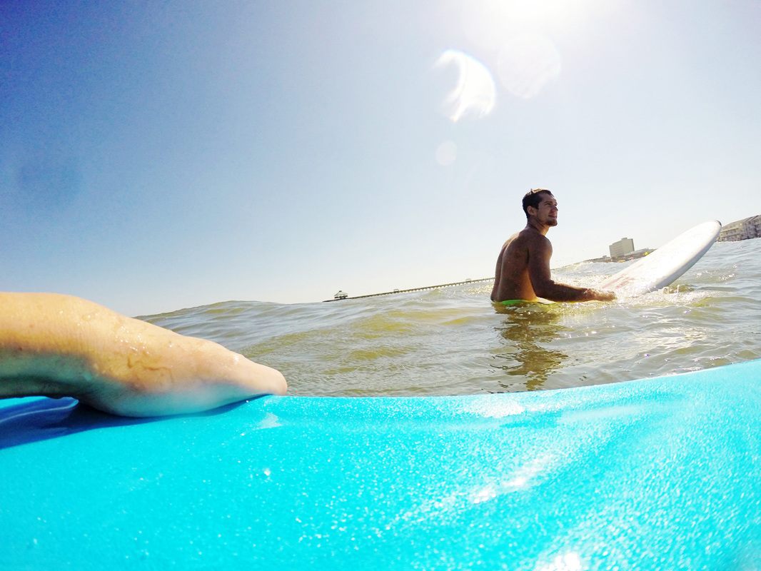 A surfer paddling out at Folly Beach, shot with a GoPro Hero 3+