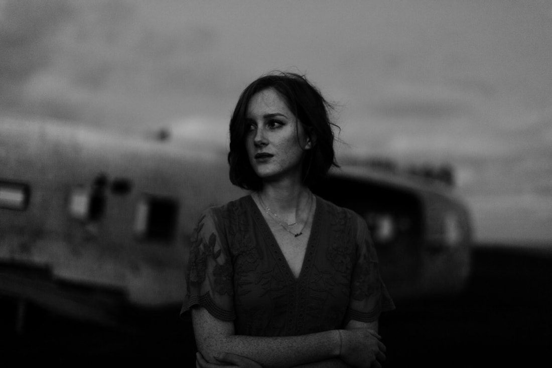 Close-up of Lindsay's expression lit by the eerie glow of the night sky