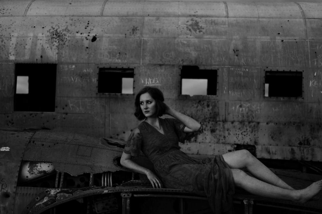 Lindsay framed by the plane wreck's open doorway at midnight
