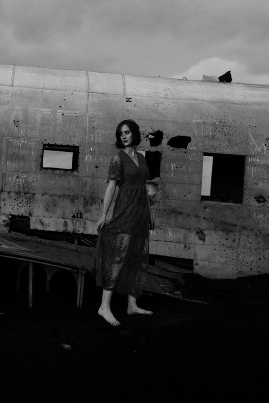 Close-up portrait of Lindsay near the metal wreckage in the cold night air
