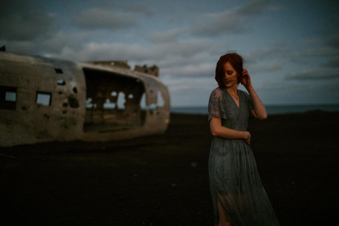 Lindsay walking away from the wreck into the soft midnight glow