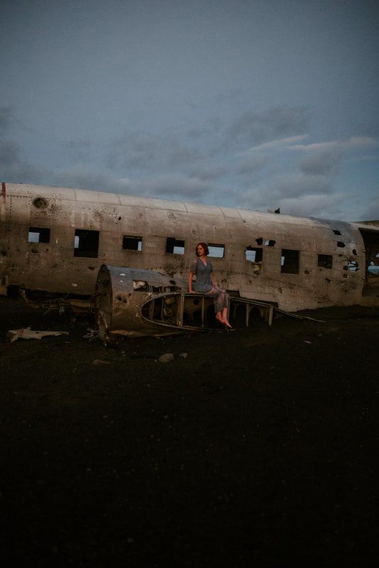 Lindsay posed near the wreckage with dramatic Icelandic sky overhead