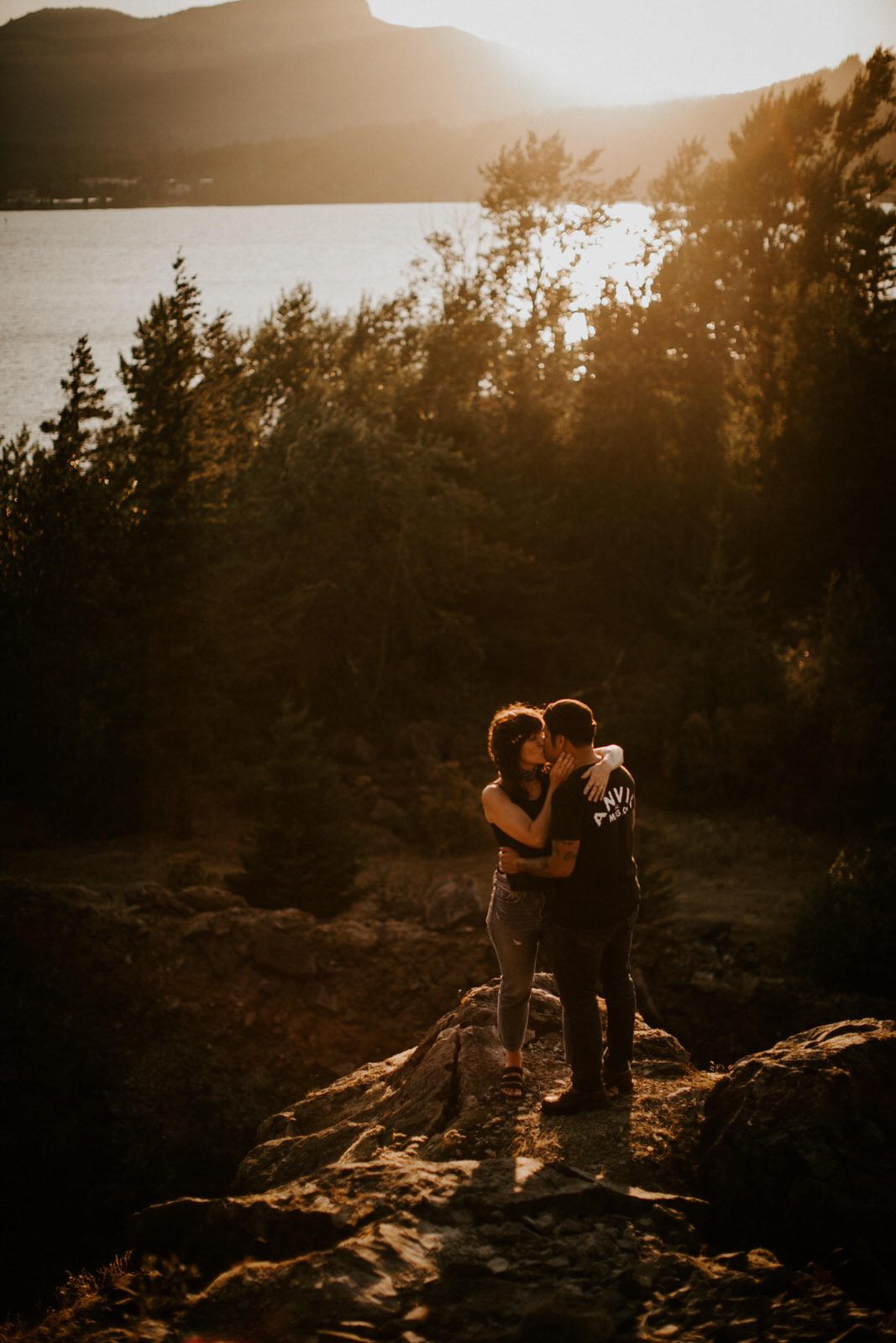 The couple sitting close together taking in the mountain view