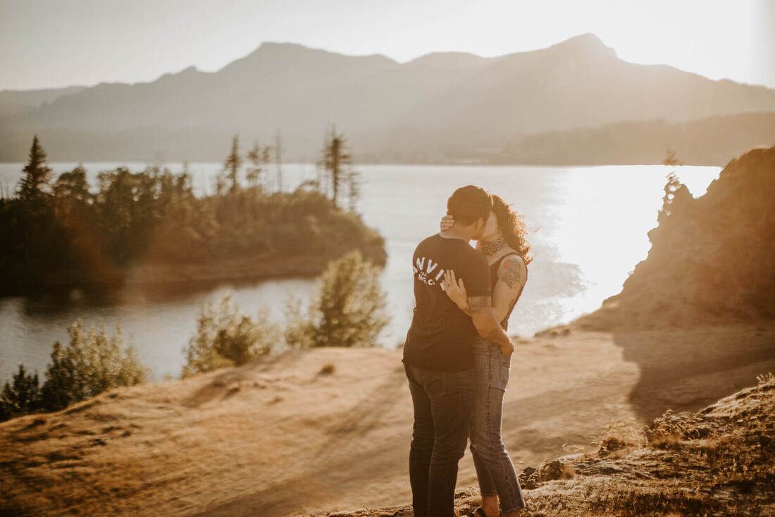 The couple sharing a quiet moment with mountain views behind them