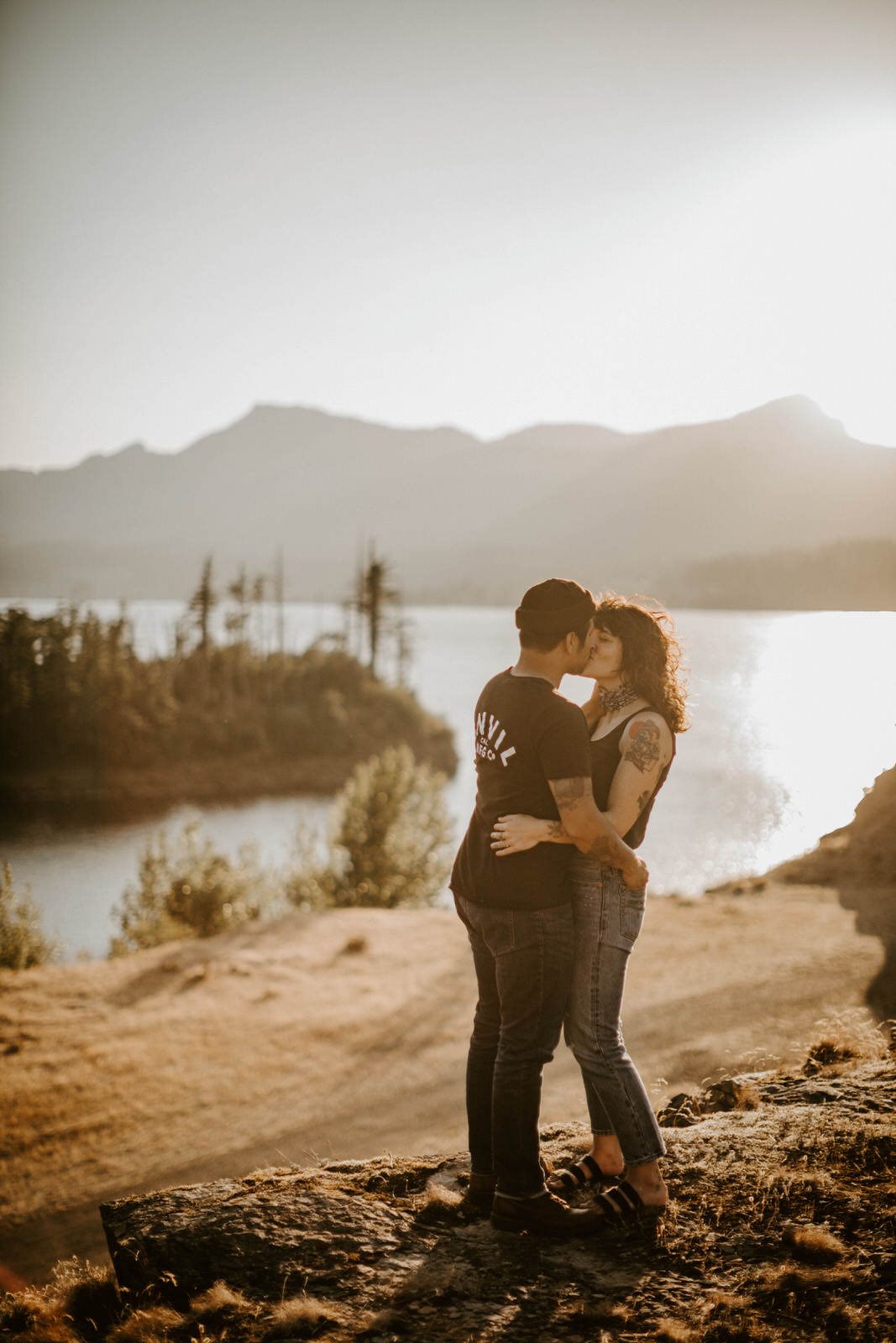 Close-up portrait of the couple embracing in the golden evening light, later in the golden hour session