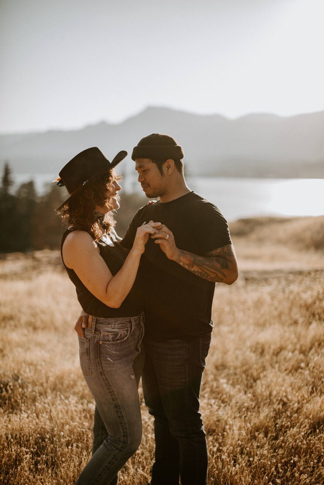 The couple embracing as the sun sets behind Mt. Hood