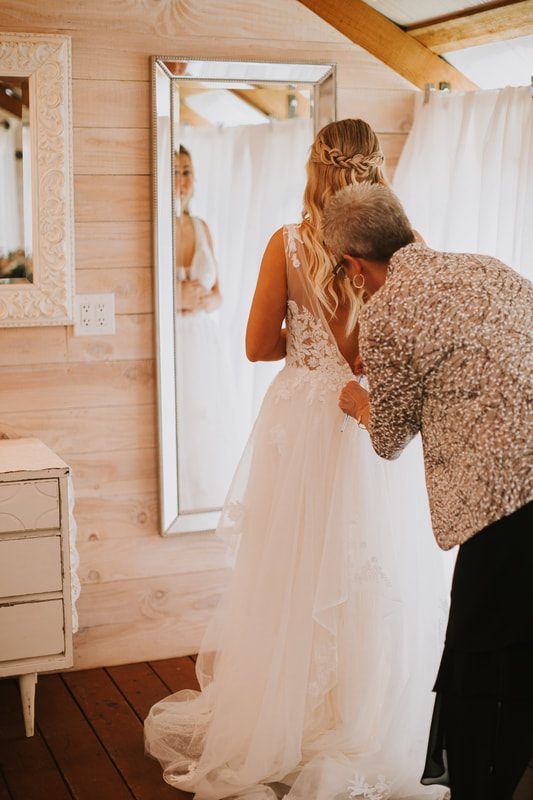 Bride walking down the aisle at a cherry orchard wedding ceremony in Chehalis, Washington.