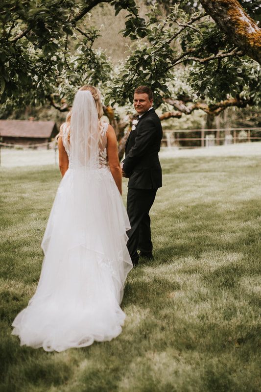 Candid moment of laughter between the bride and groom during their Chehalis wedding.