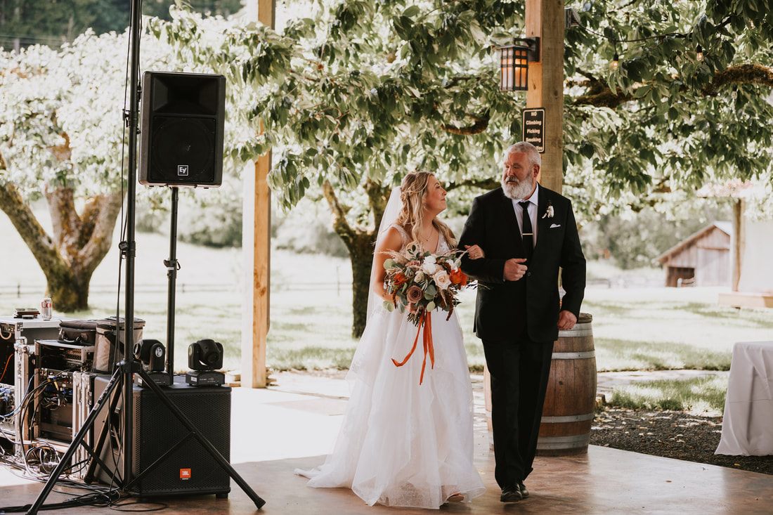 Bride and groom's first dance at their orchard wedding reception in Chehalis, Washington.