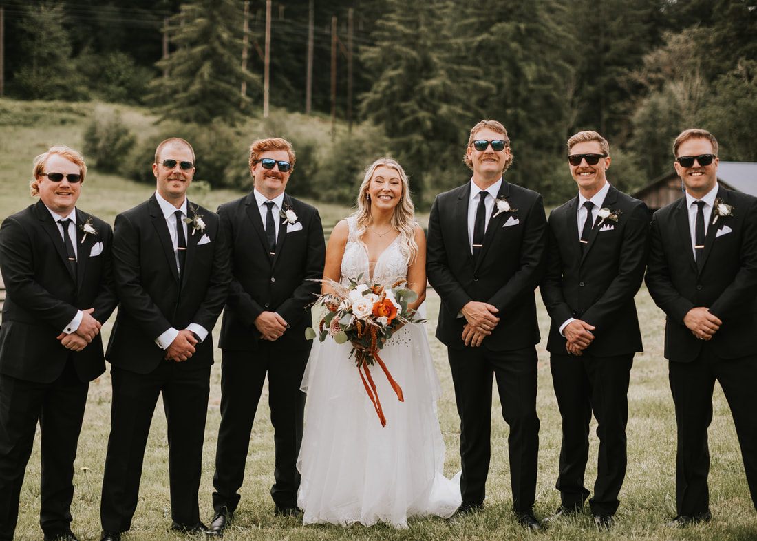 Outdoor wedding ceremony beneath cherry trees at The Orchard at Sunshine Hill in Chehalis, WA.