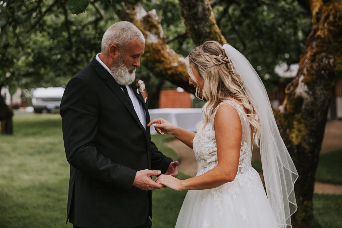 Bride and groom cutting their wedding cake at the orchard reception.