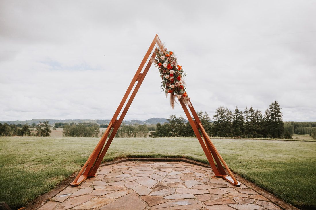 First kiss as newlyweds at their cherry orchard wedding ceremony in Chehalis, WA.