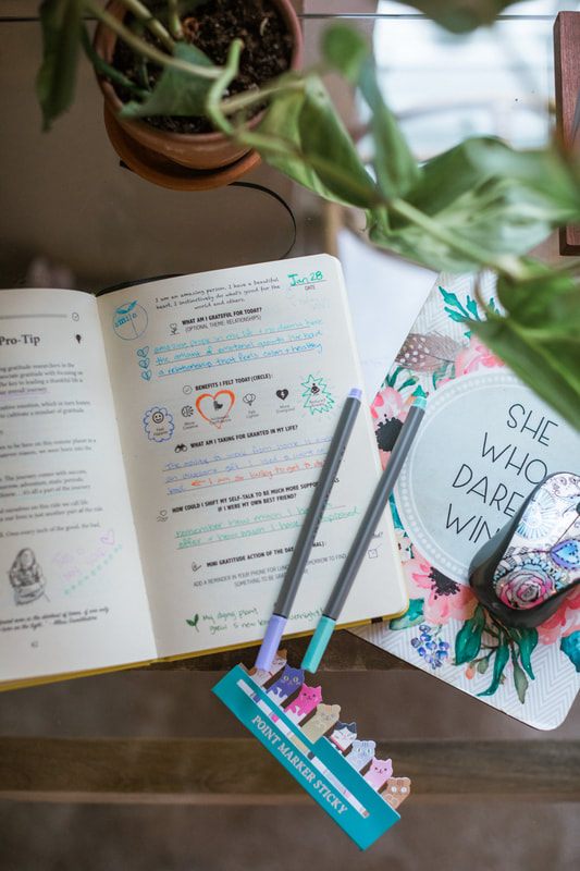 Styled lifestyle shot of the Habit Nest journal in use