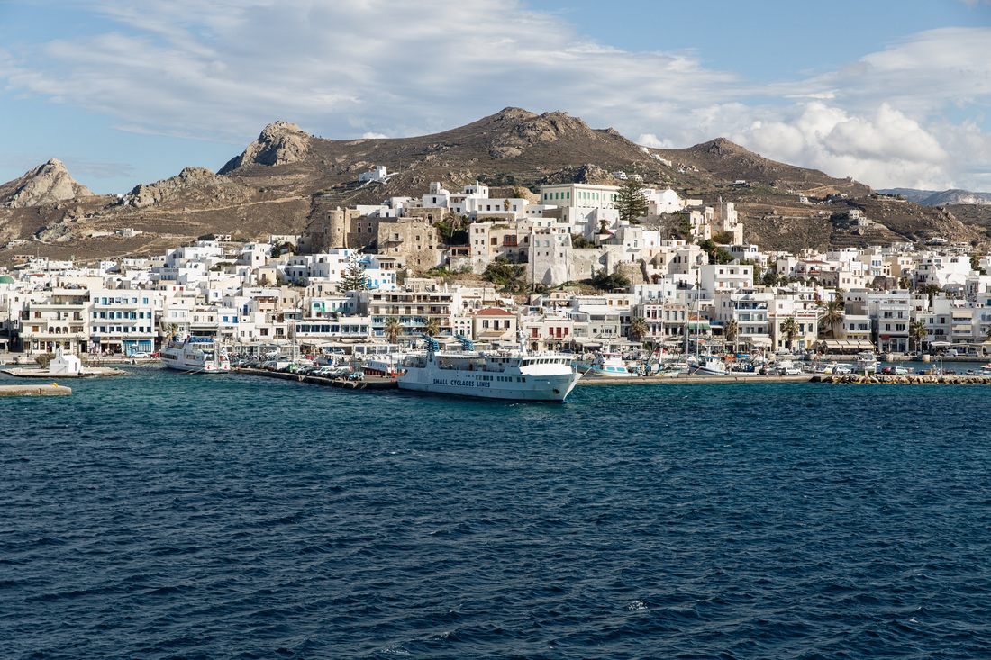 Whitewashed buildings and blue domes overlooking the caldera in Santorini, Greece
