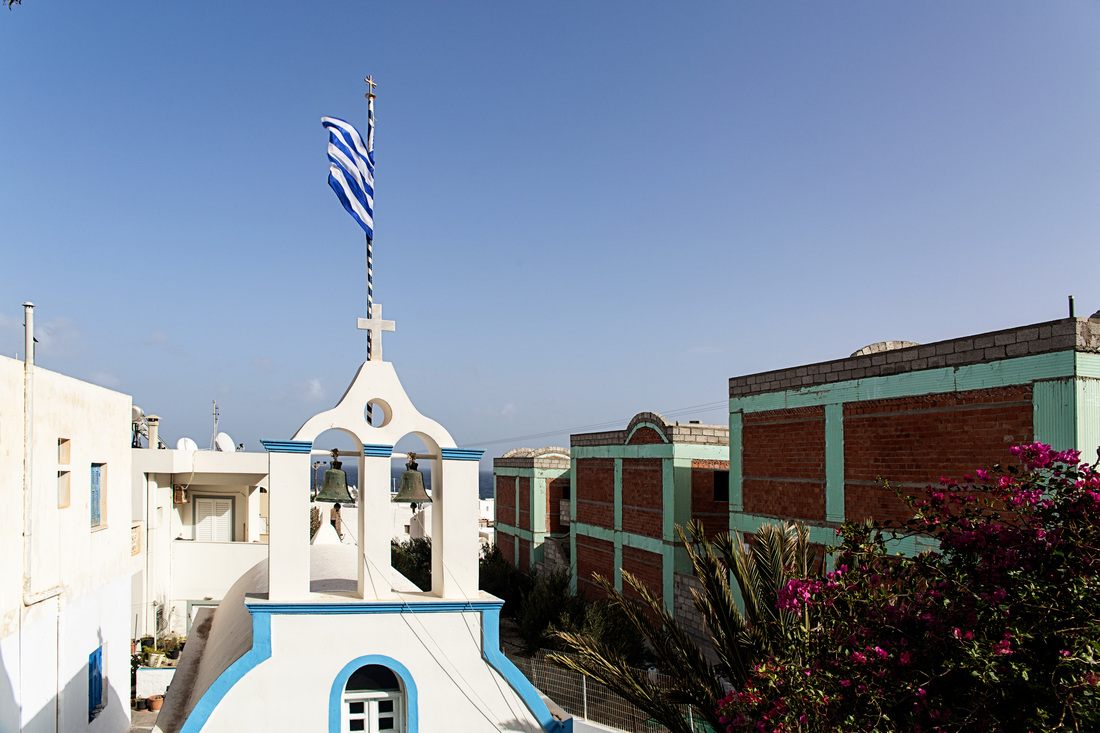 Whitewashed buildings and blue domes overlooking the caldera in Santorini, Greece