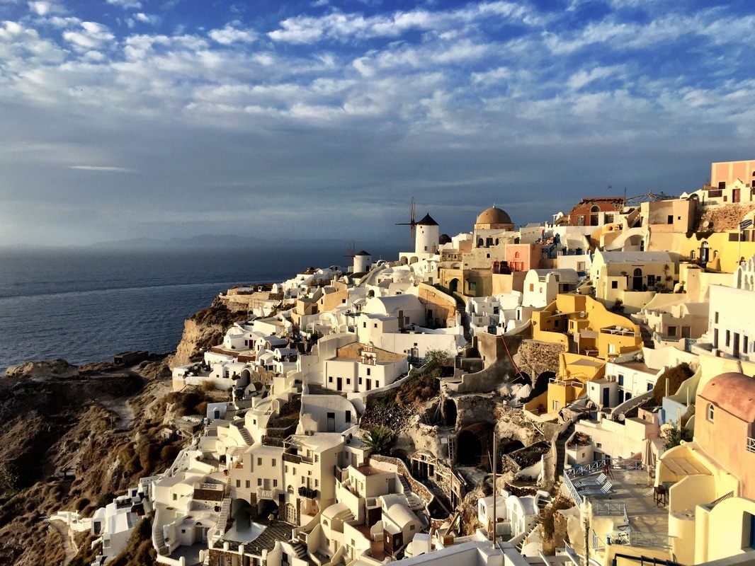 Volcanic black sand and turquoise water along the Santorini coast