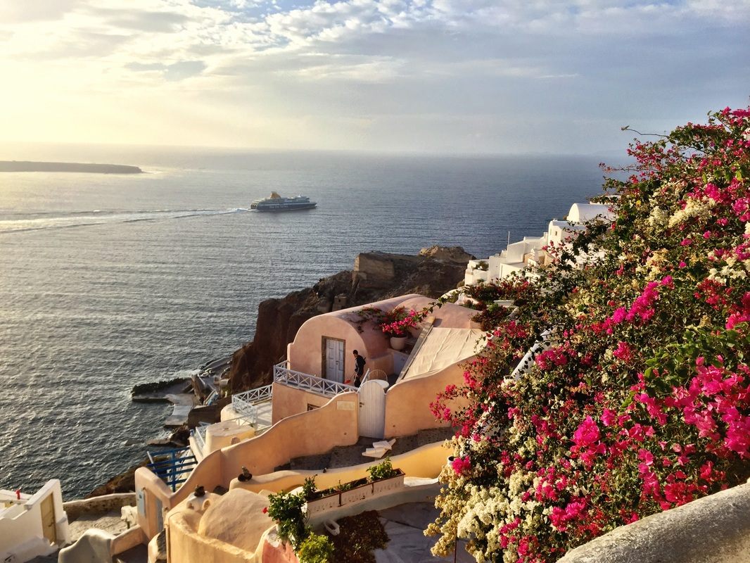 Whitewashed buildings and blue domes overlooking the caldera in Santorini, Greece