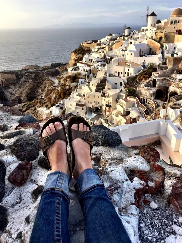 Sunset over the Aegean Sea from a cliffside village in Santorini