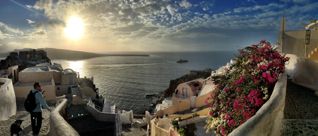 Narrow winding streets lined with white buildings in Santorini, Greece