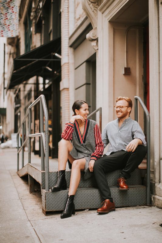 Couple posing on a busy New York City corner during their photo session