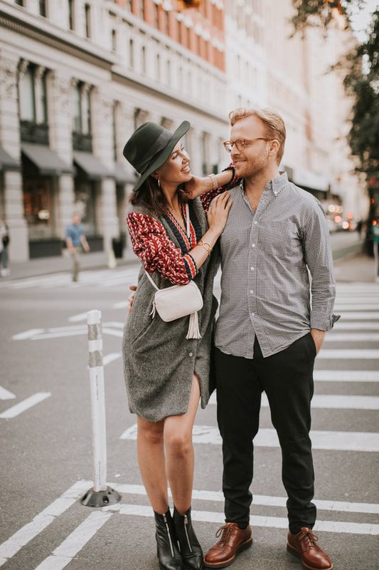 Engagement portrait with the couple framed by New York architecture