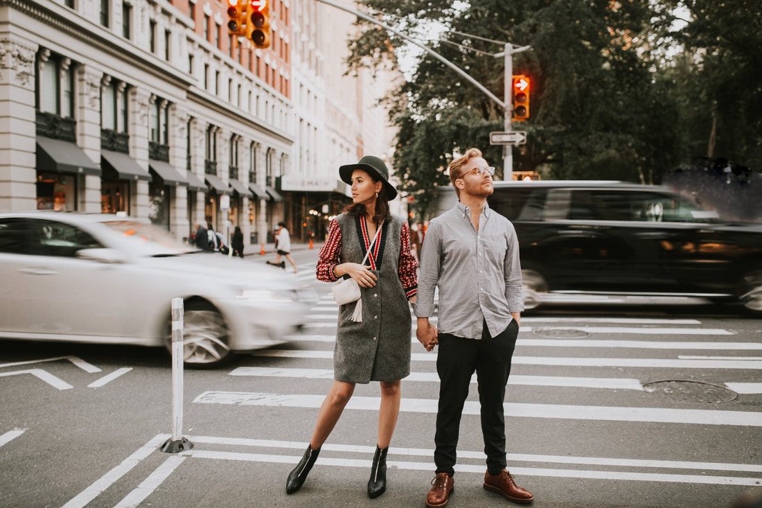 Karina and Matt posing near classic NYC brownstone steps