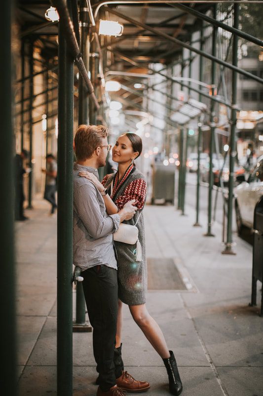 Couple laughing together as they explore the Flatiron District at night