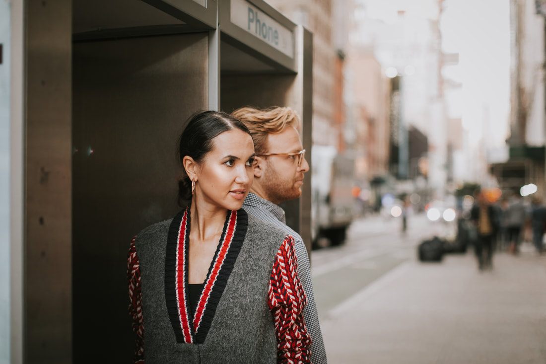 Close-up of the couple's hands during their engagement photos in the city