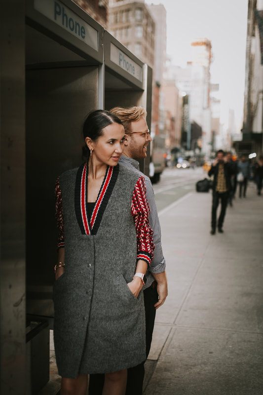 Couple walking through the city as evening falls during their session