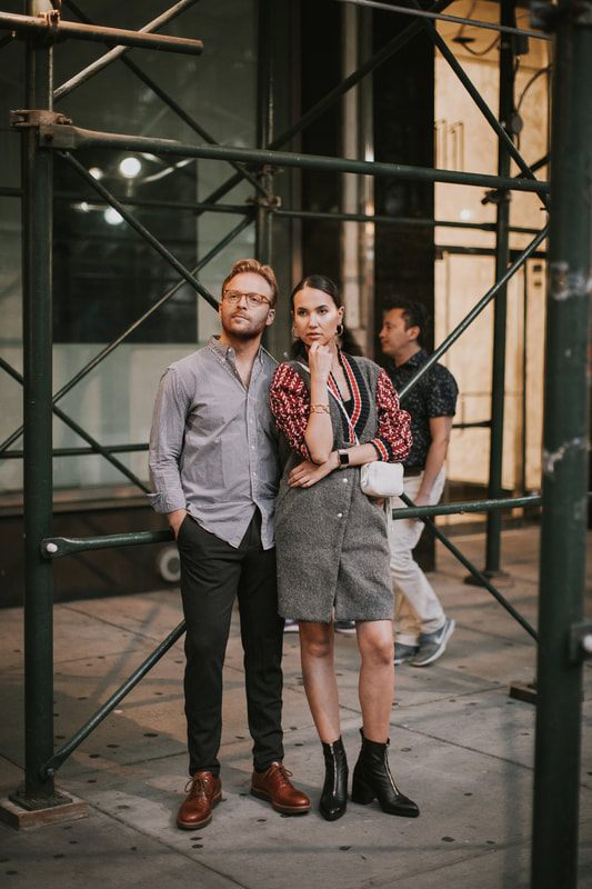Close-up portrait of the couple with the city lit up behind them