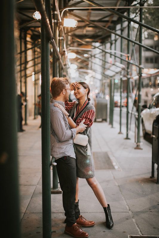 Candid portrait of the couple walking through New York at night