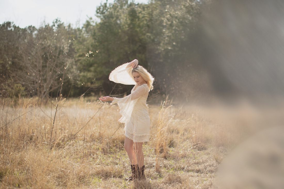 Outdoor boudoir session portrait against a natural backdrop